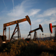 Pump jacks and wells are seen in an oil field on the Monterey Shale formation where gas and oil extraction uses fracking.